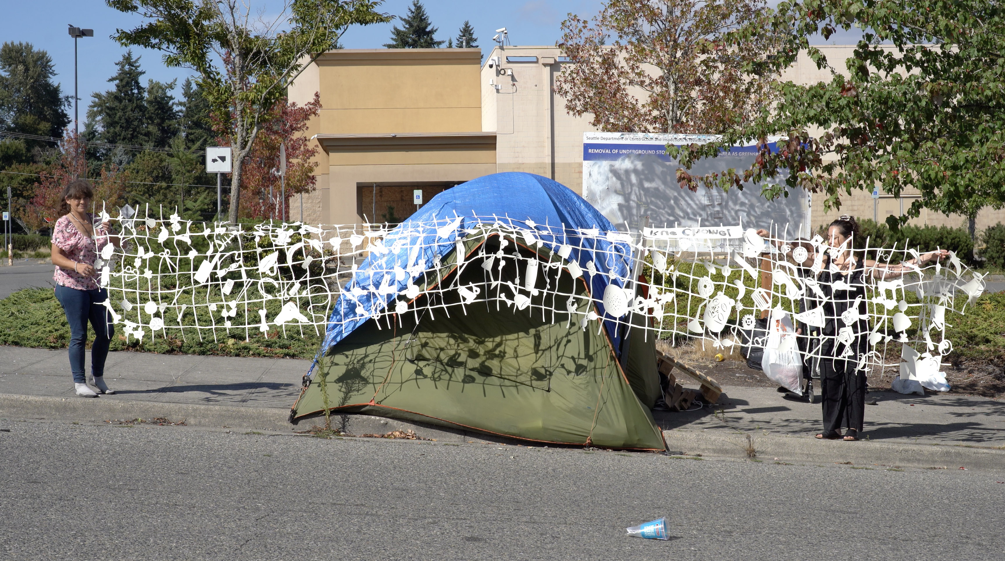 Lauren Iida's paper art installation at community event with tent